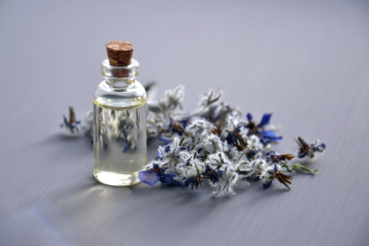 featured-images-01 Close-up of a lavender oil bottle with dried flowers for aromatherapy. Perfect for wellness themes.